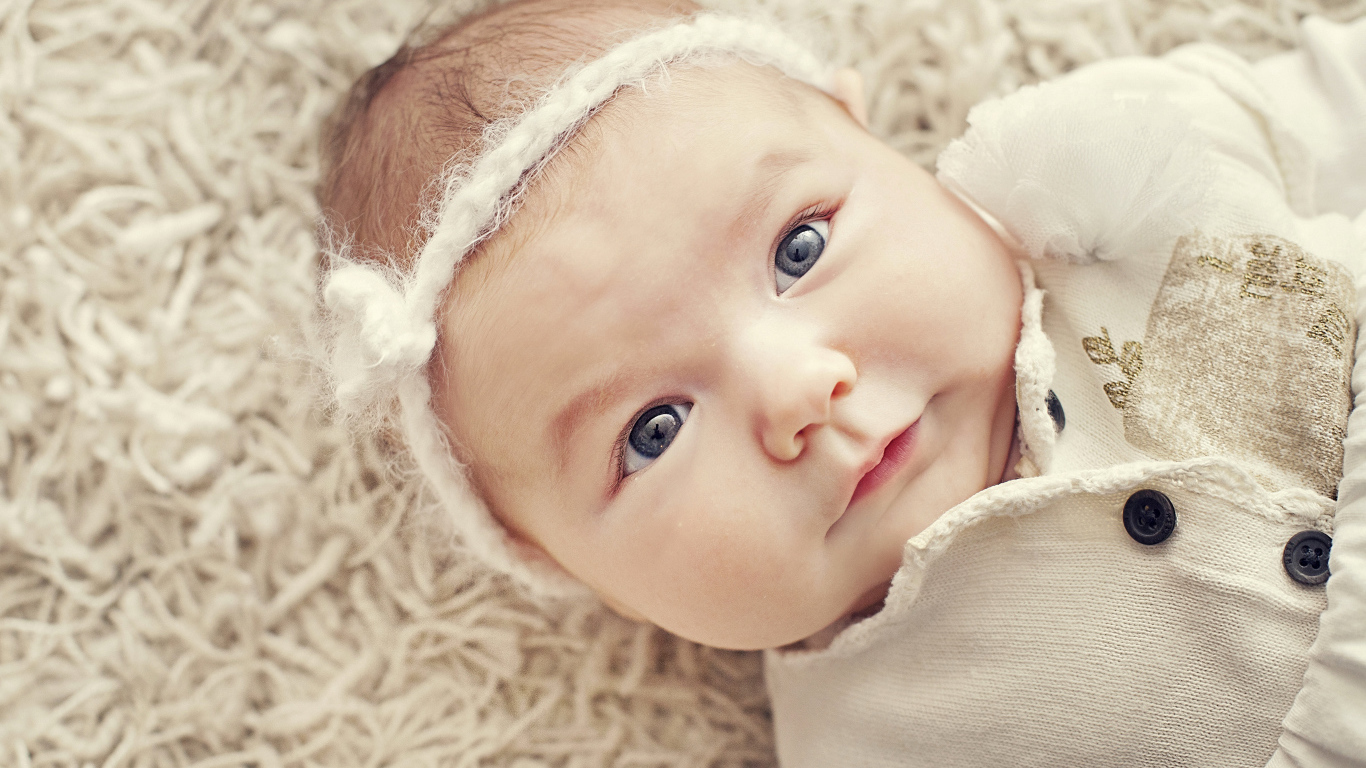 Красивая голубоглазая малышка с повязкой на голове