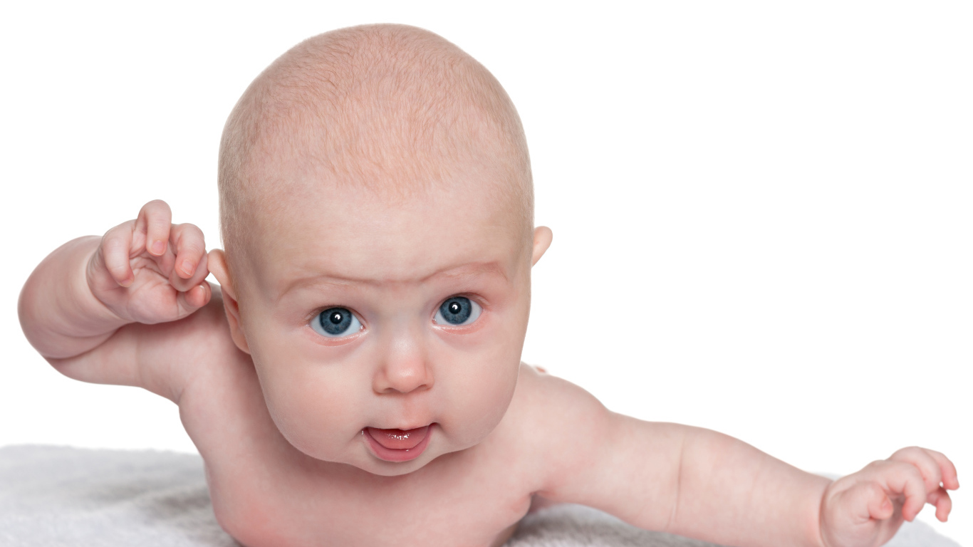 Голубоглазый малыш лежит на белом фоне