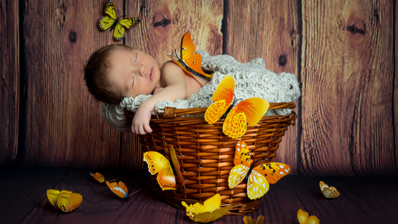 Милый спящий младенец в корзине с бабочками