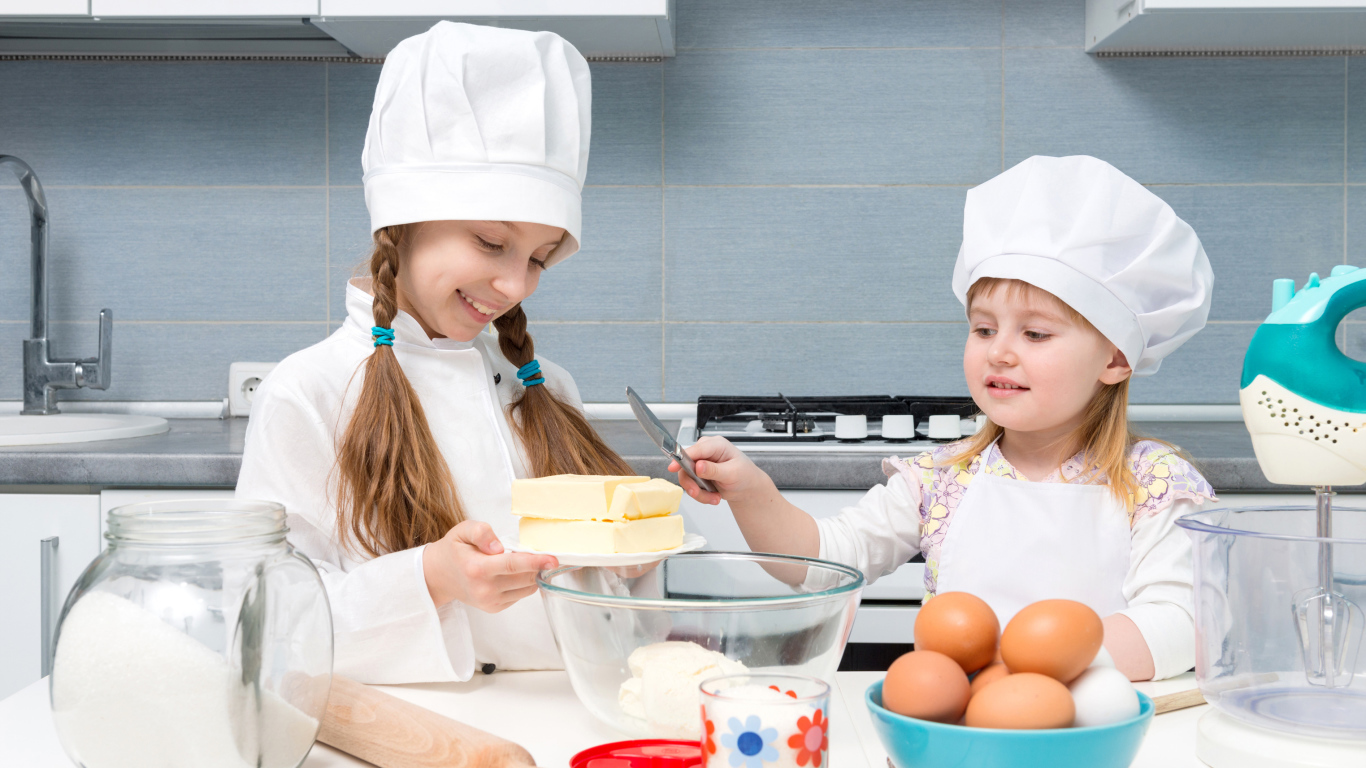 Две маленькие девочки на кухне готовят пирог