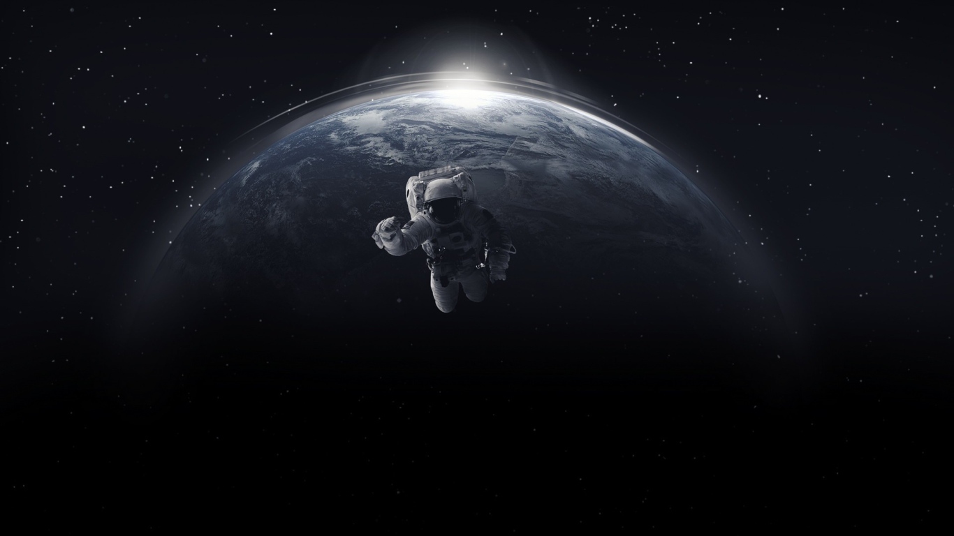 Astronaut in open space against the backdrop of the planet earth