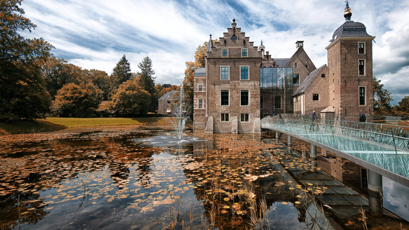 Castle Huis te Ruurlo near the water under the beautiful sky, Netherlands