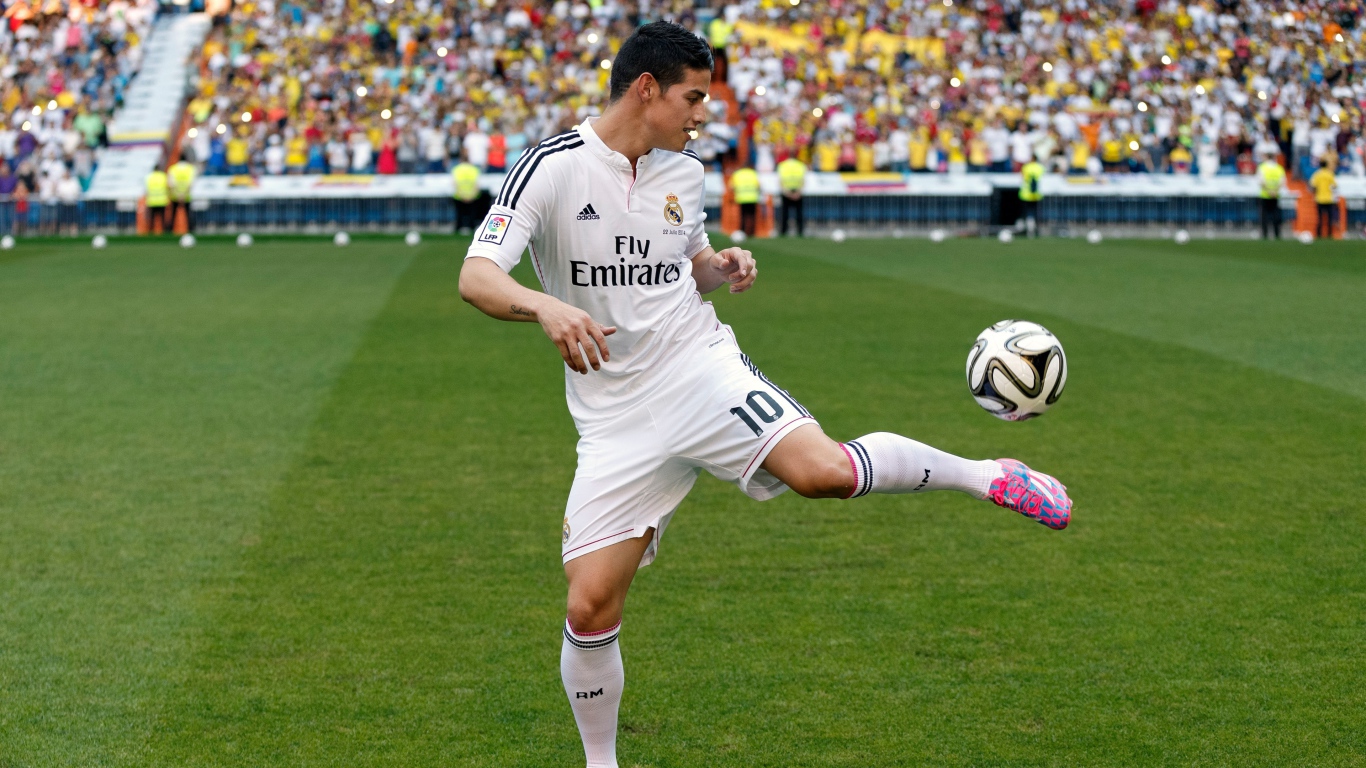 Football player James Rodriguez plays with a ball
