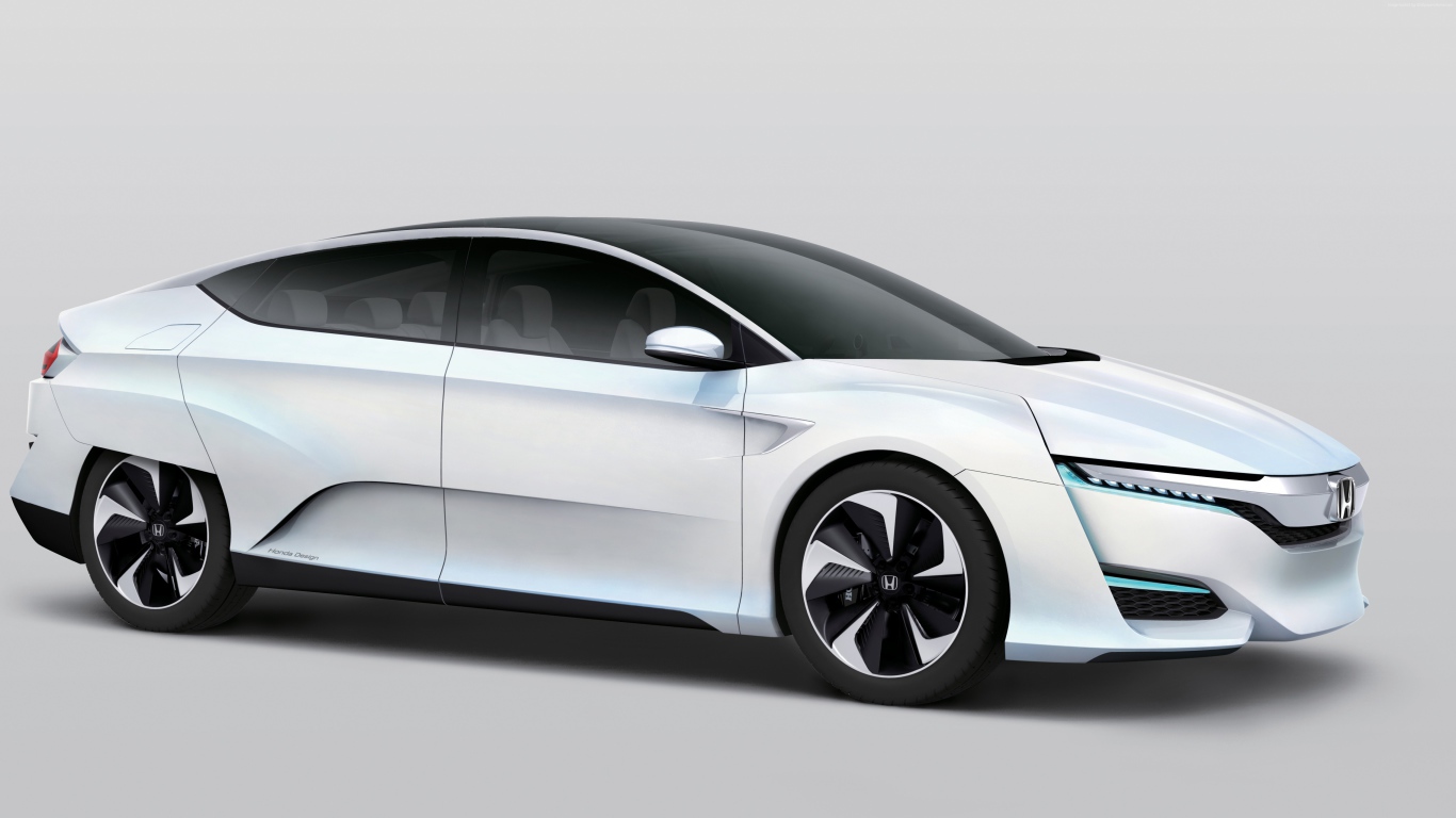 Белый электромобиль  Honda FCv на сером фоне
