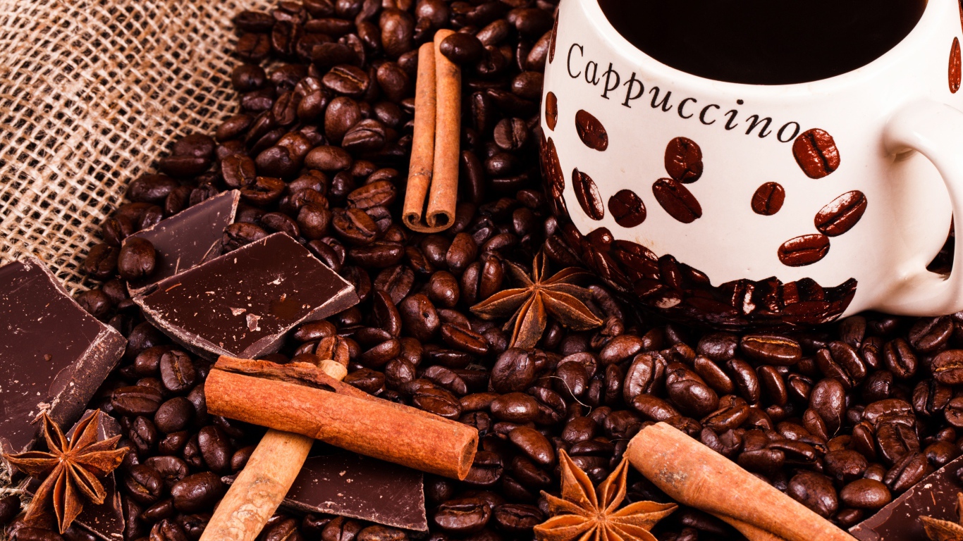 Чашка кофе с кофейными зернами, корицей, шоколадом и бадьяном 