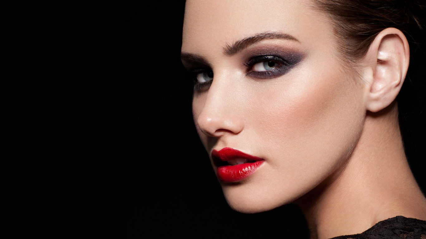 Красивая девушка с яркой помадой на губах на черном фоне