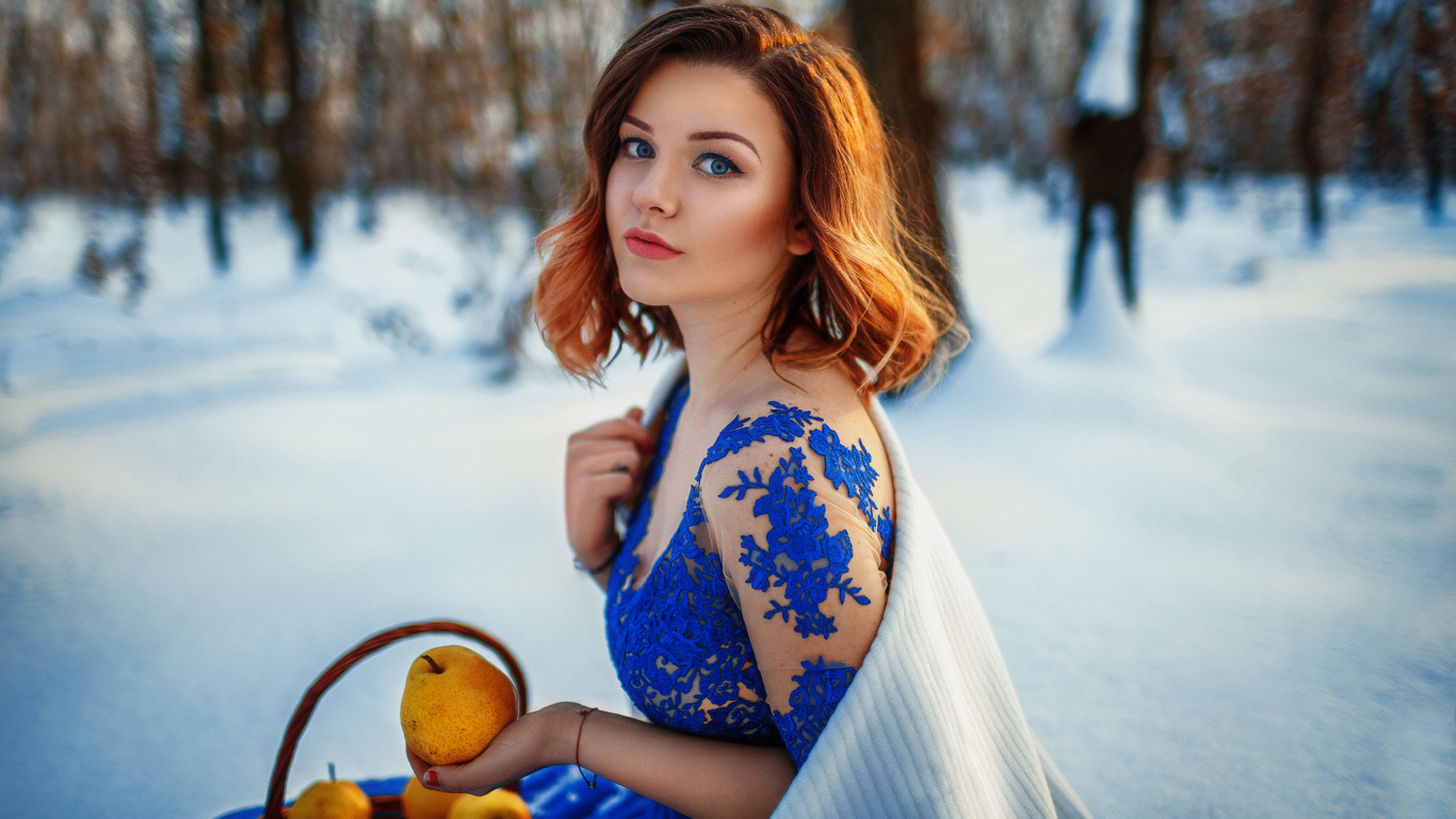 Красивая девушка с грушами в заснеженном лесу