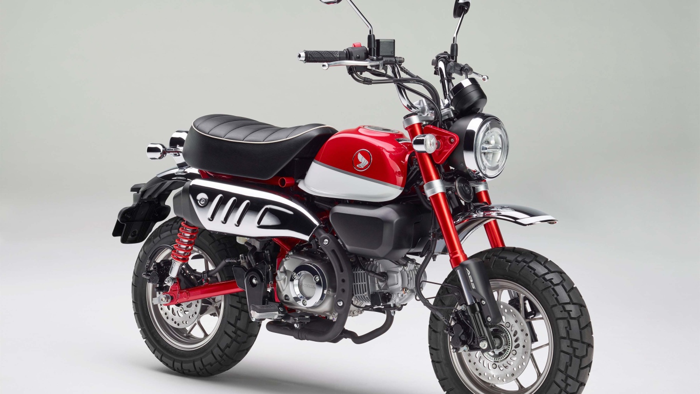 Красный мотоцикл Honda Monkey, 2018 года на сером фоне