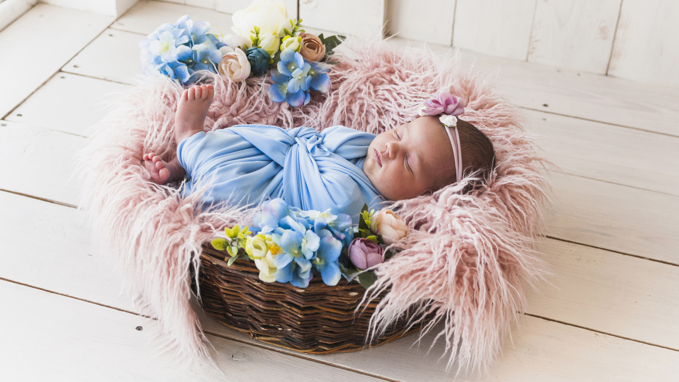 Маленький грудной ребенок спит в плетеной корзине 