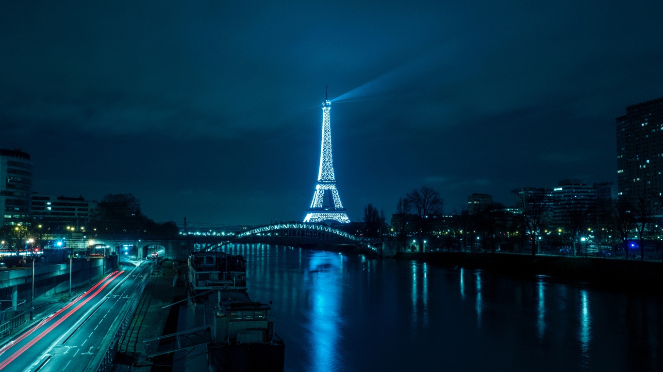 Eiffel Tower at night on the canal background, France