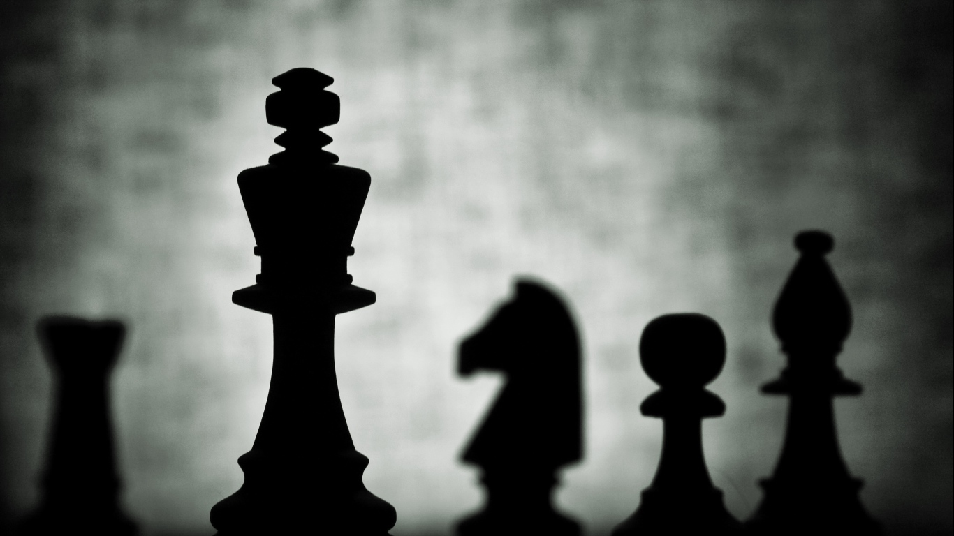 Chess silhouettes on chessboard