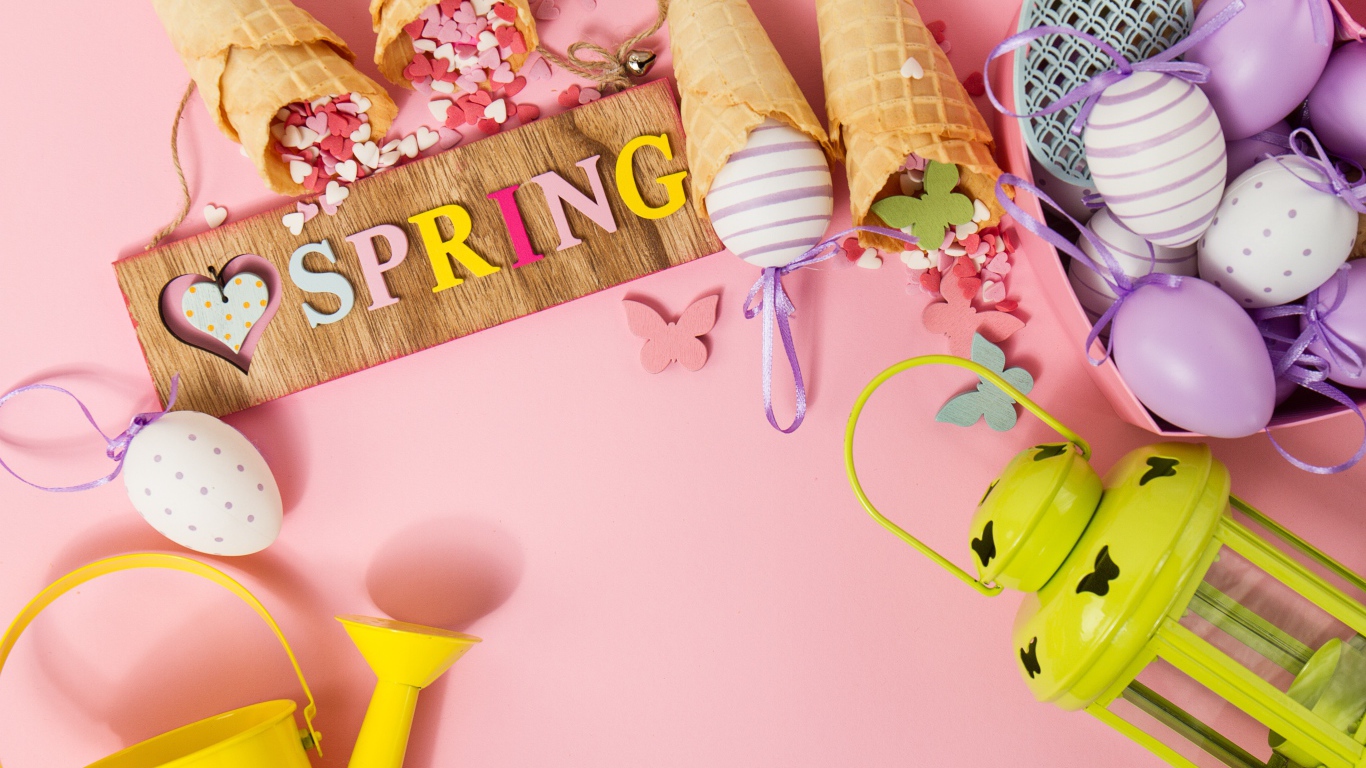 Надпись весна с вафельными рожками и яйцами на розовом фоне