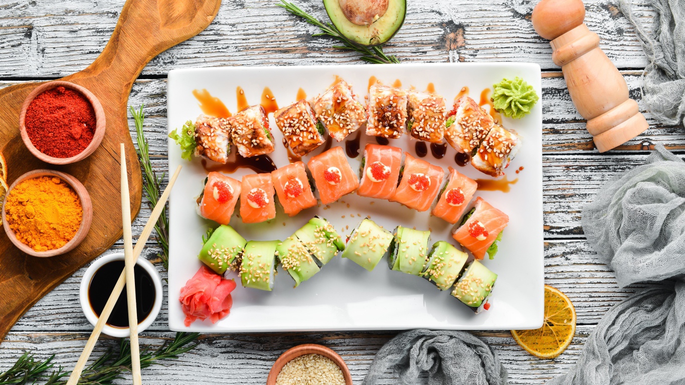 Вкусные аппетитные японские роллы на столе с соусом и специями