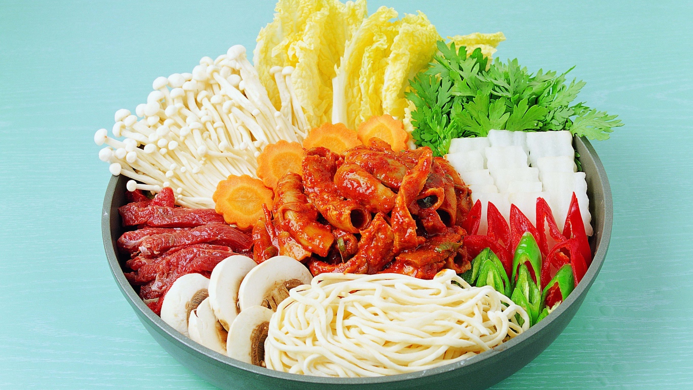 Мясо в тарелке с овощами, грибами и лапшой на голубом фоне