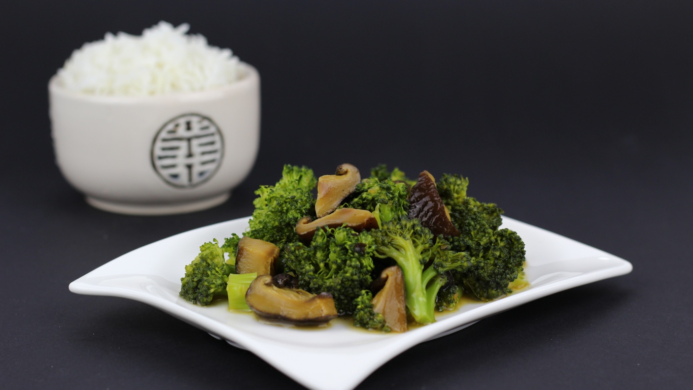 Salad with broccoli and mushrooms on a gray background with rice