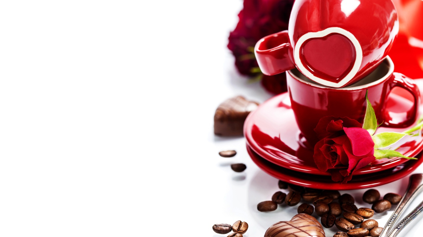Красные чашки на белом фоне с шоколадными конфетами и кофейными зернами