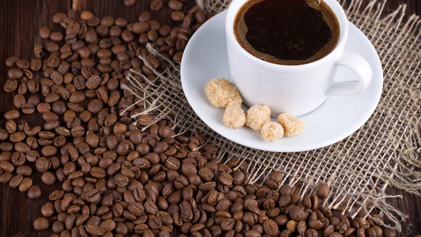 Чашка кофе с зернами на столе 