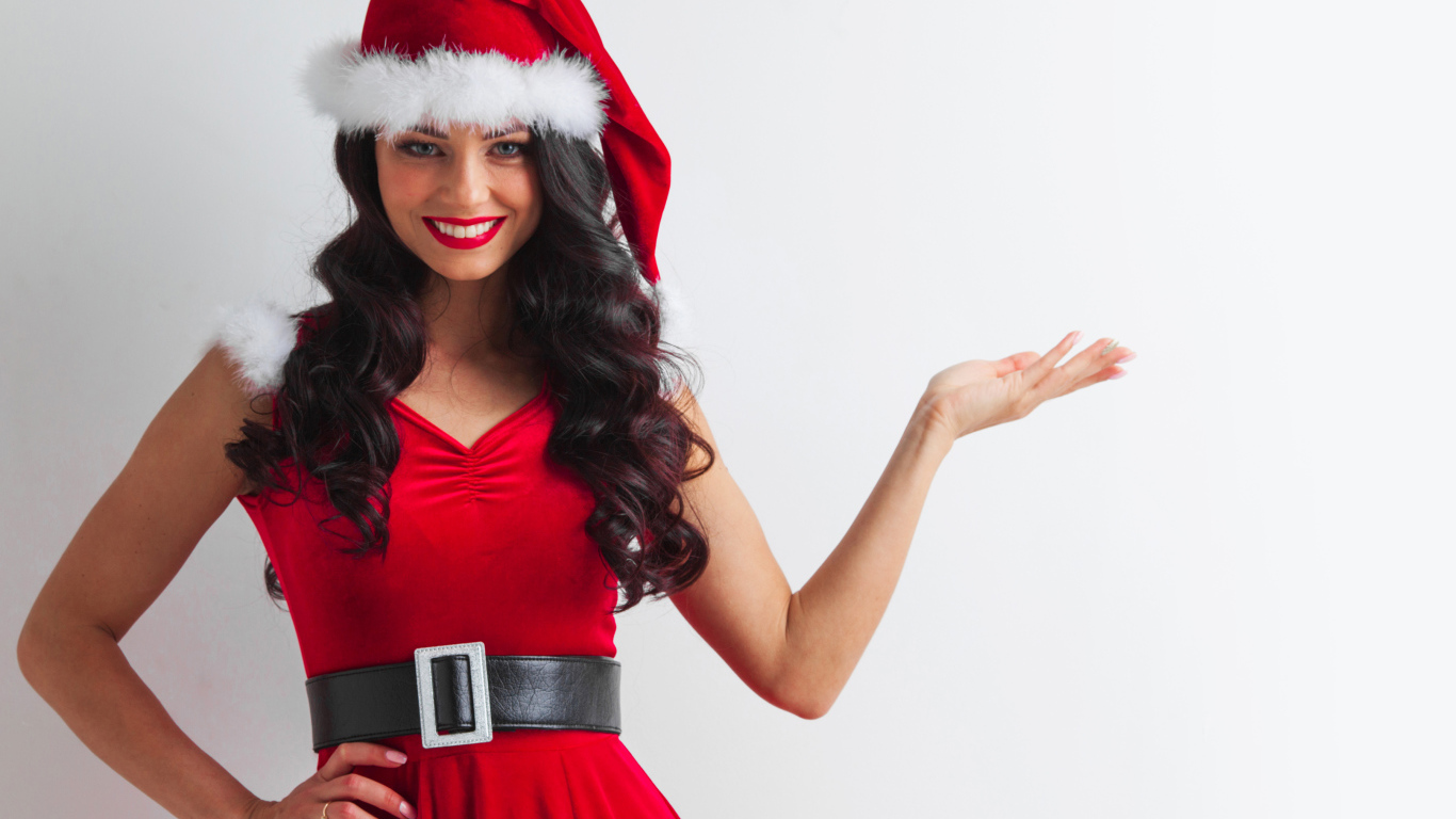 Улыбающаяся девушка в новогоднем костюме на сером фоне