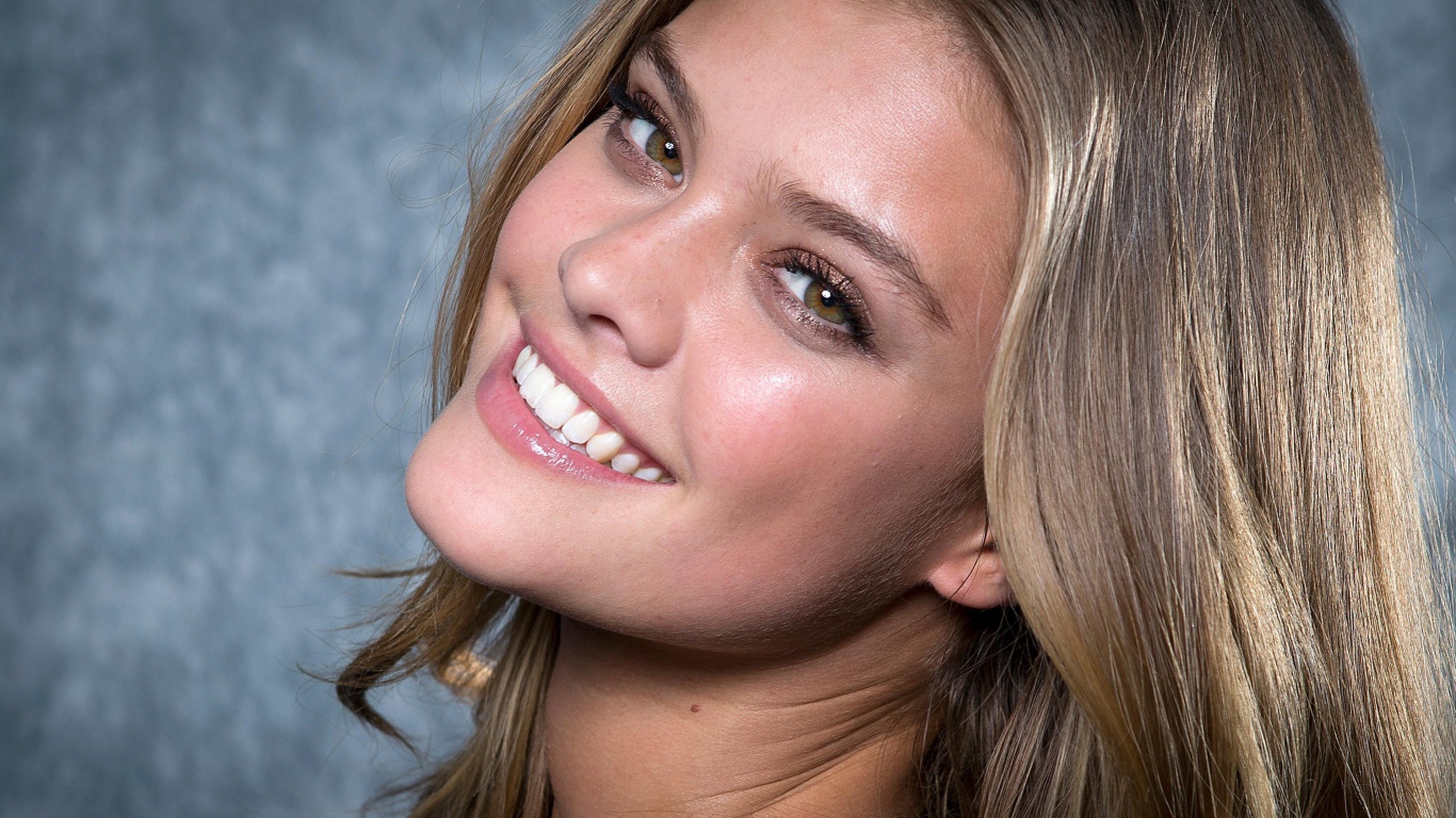 Smiling model Nina Agdal face close-up.