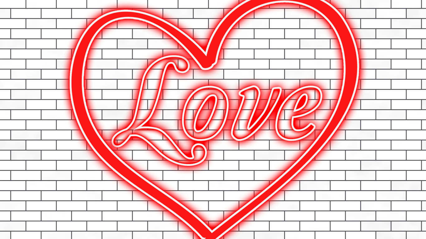 Красное сердце с надписью Любовь на кирпичной стене