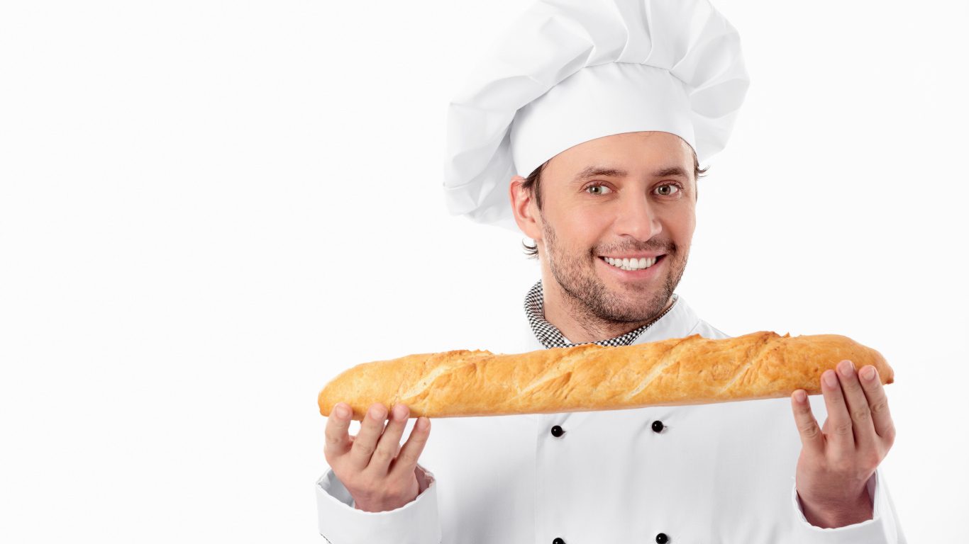 Мужчина повар в костюме с батоном в руках 