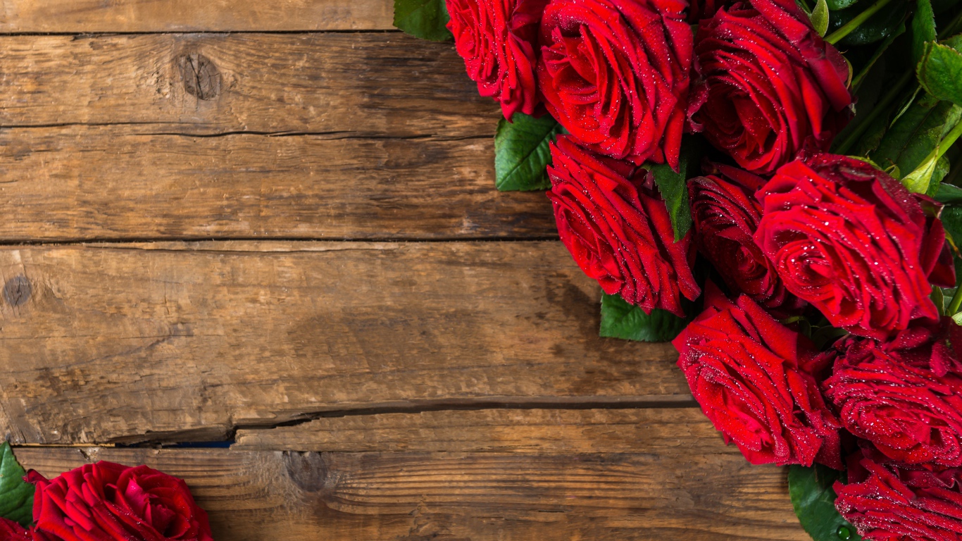 Красивый букет красных роз на деревянном фоне
