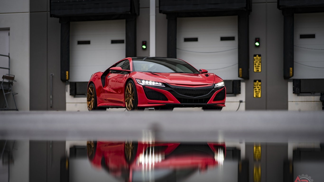 Красный спортивный автомобиль Acura NSX в гараже