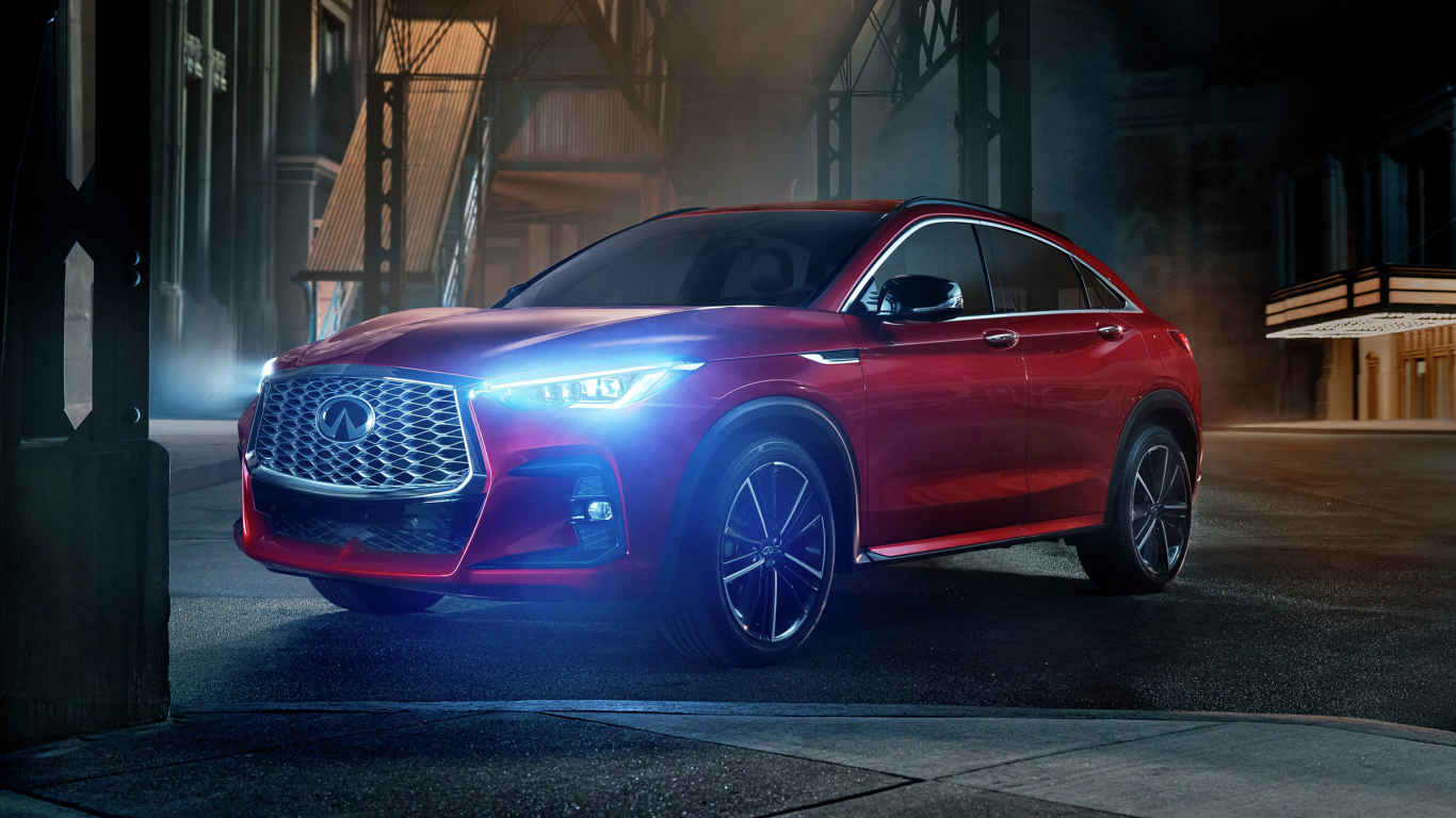 Красный автомобиль Infiniti QX55 AWD, 2022 года с включенными фарами