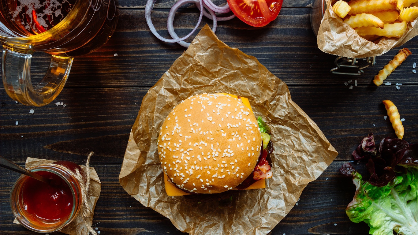 Еда из фаст фуда на столе с пивом 