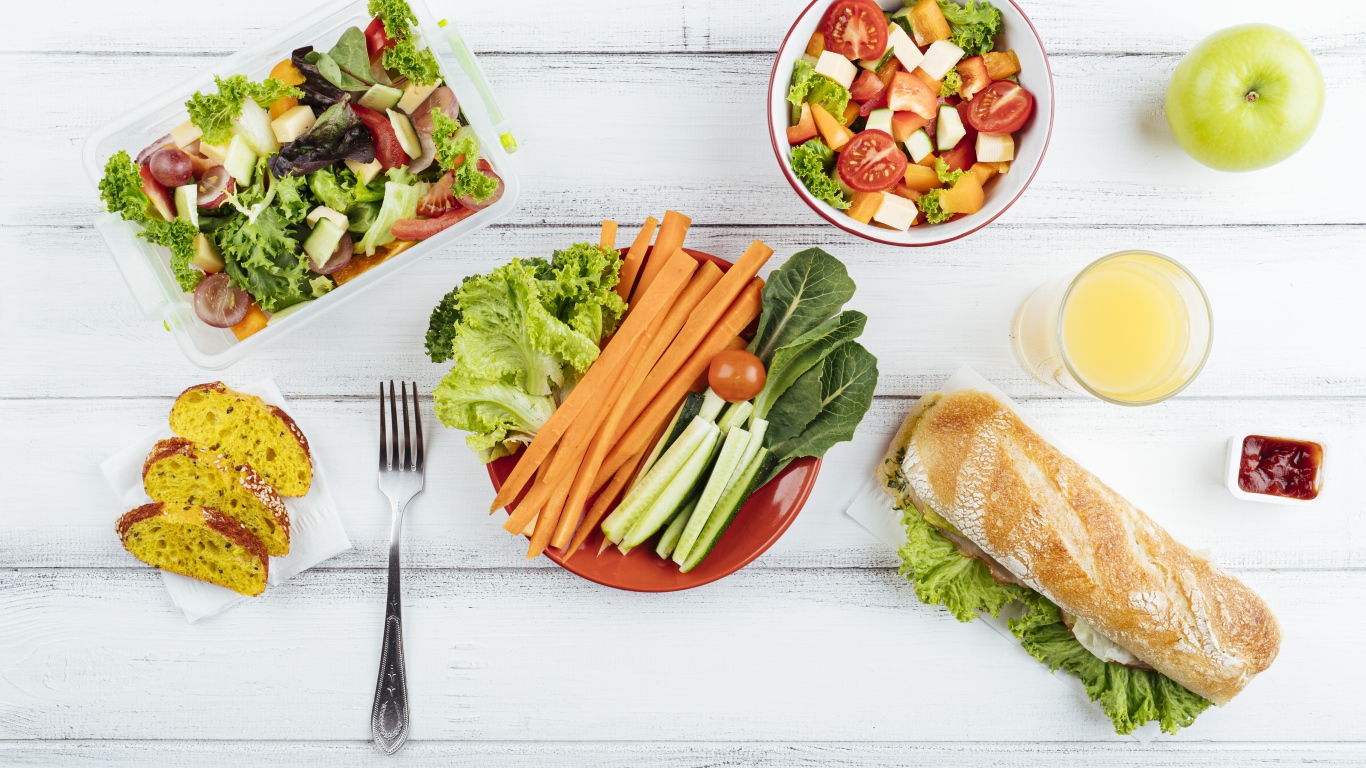 Салат из свежих овощей на столе с бутербродом 