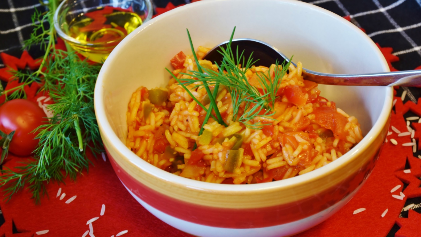 Рис с овощами в тарелке на столе