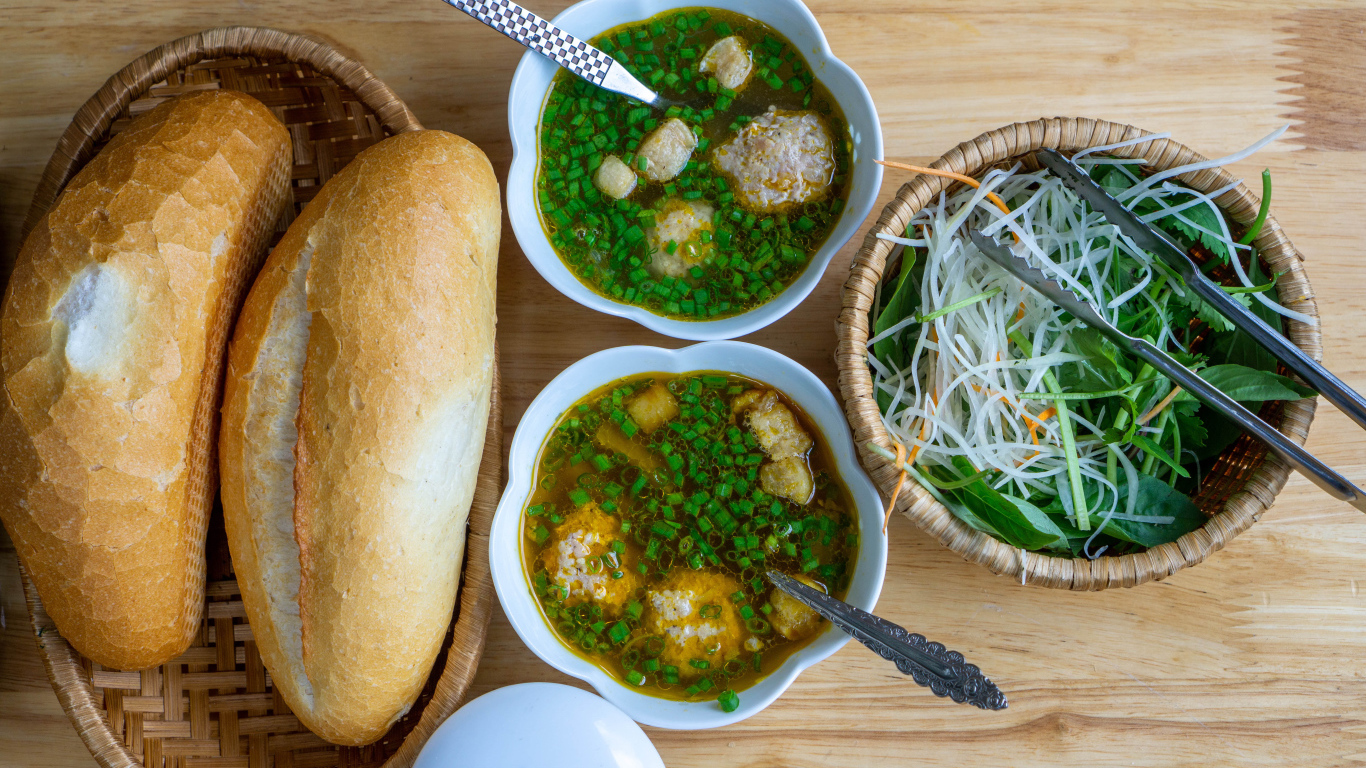 Суп с фрикадельками на столе с хлебом и салатом 