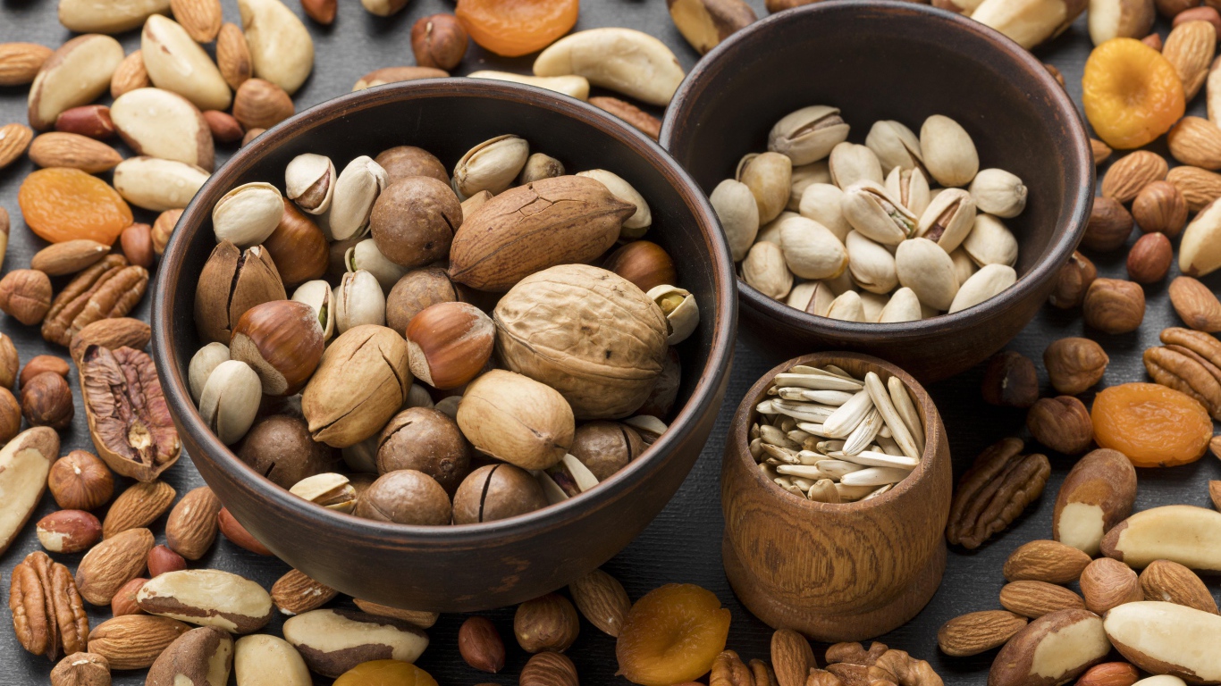 Different types of nuts on the table in bowls