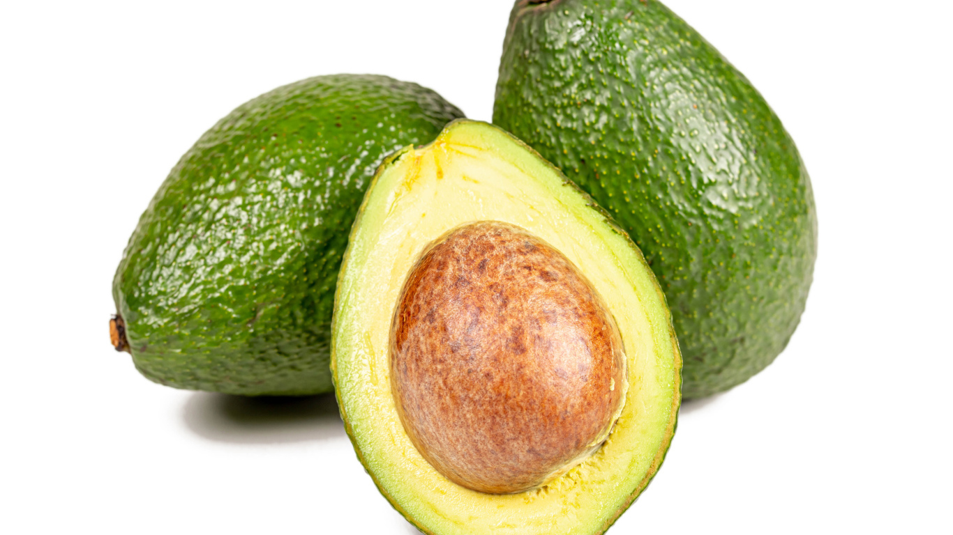 Зеленые плоды авокадо на белом фоне