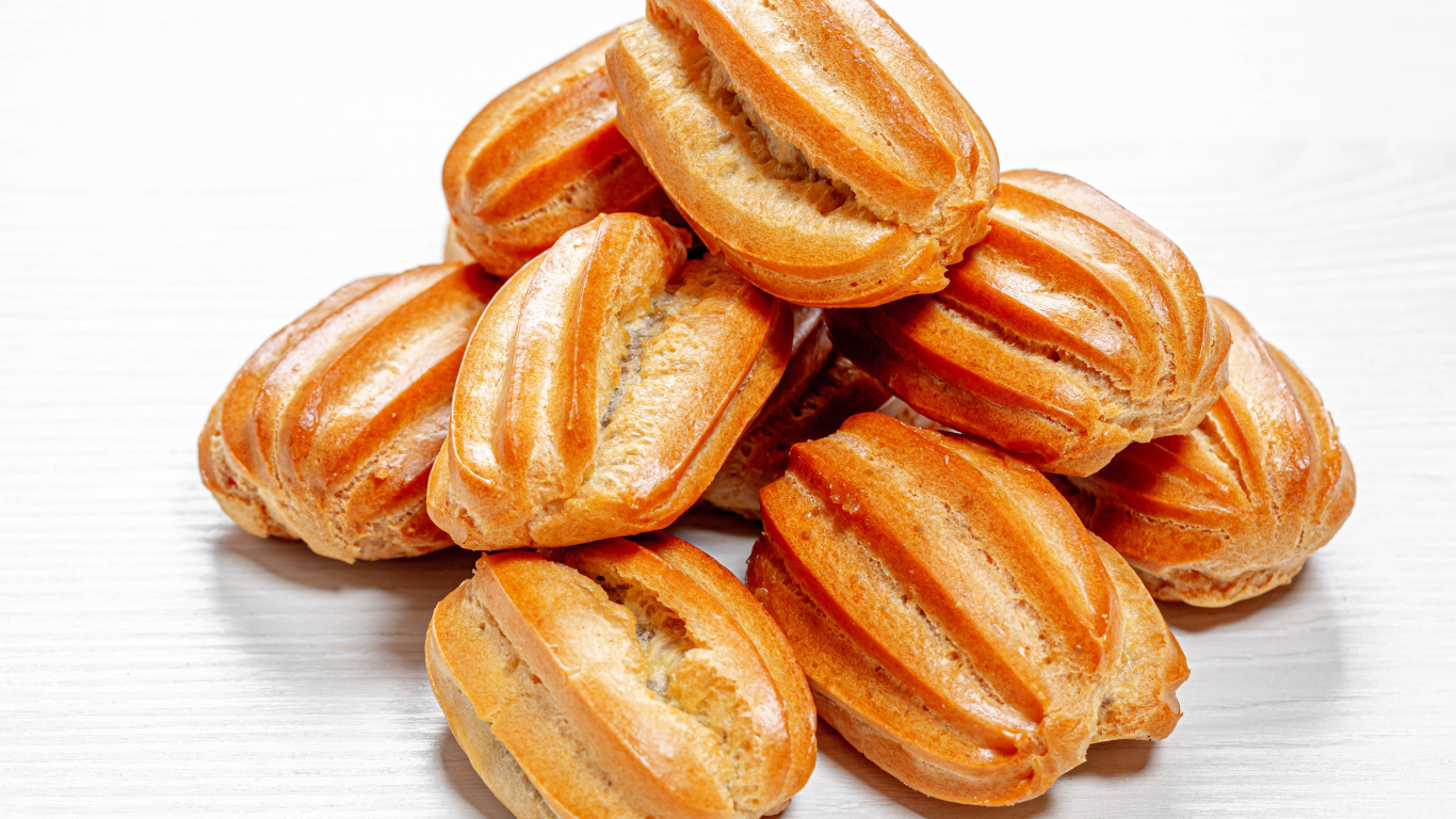 Свежие эклеры на белом фоне