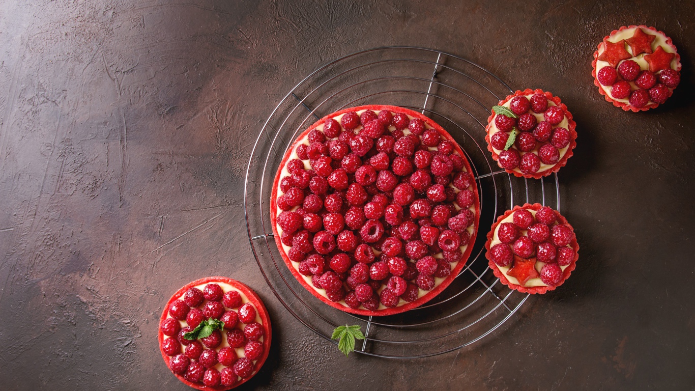 Пирог с малиной и кексы с малиной на столе 