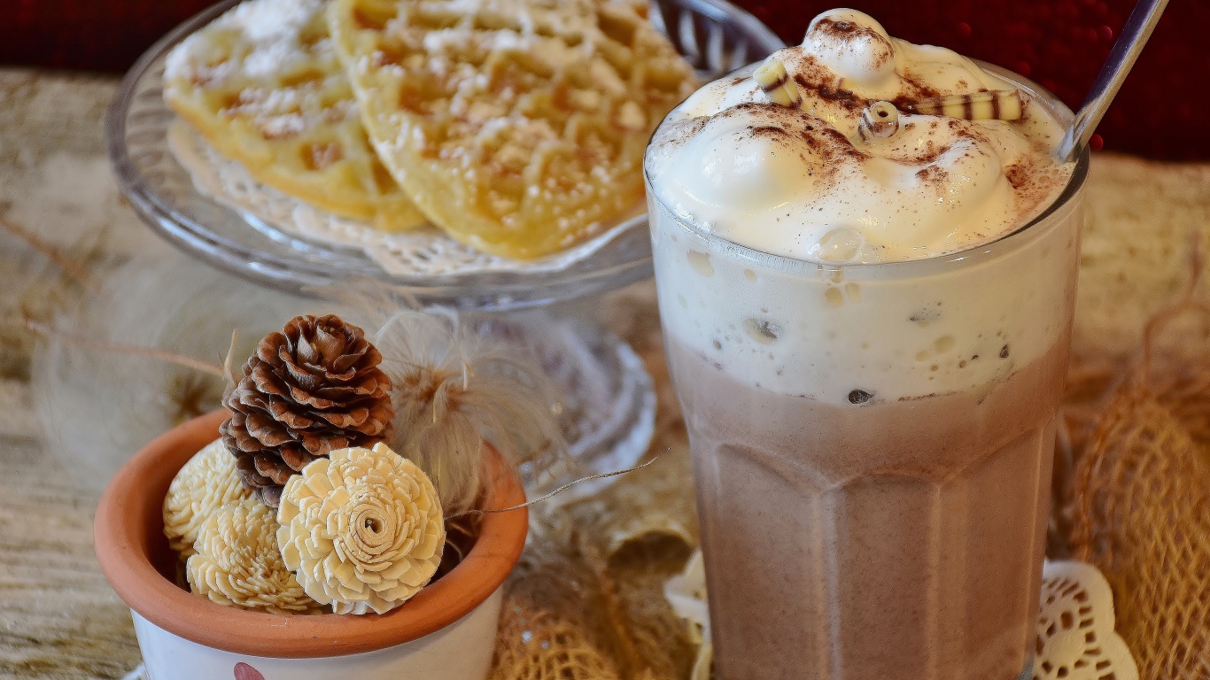 Горячий шоколад со сливками на столе с печеньем