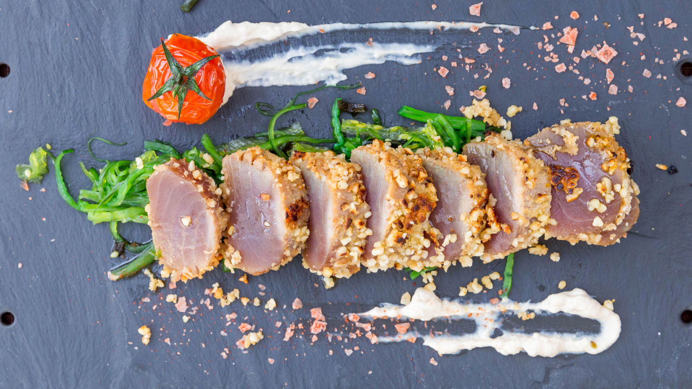 Вяленое мясо на столе с зеленью и помидором 