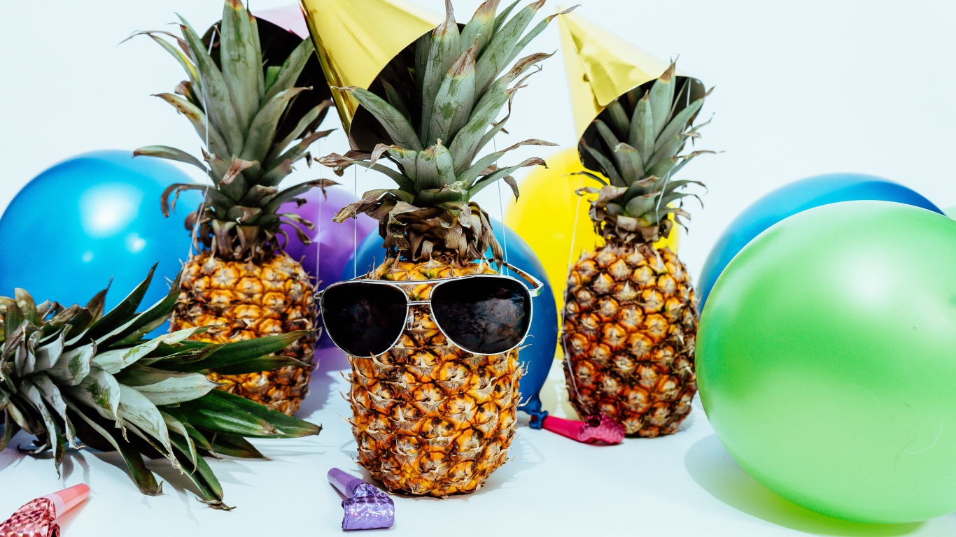 Pineapples in glasses with balloons