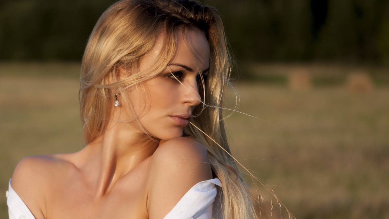 Красивая длинноволосая блондинка в белой рубашке 