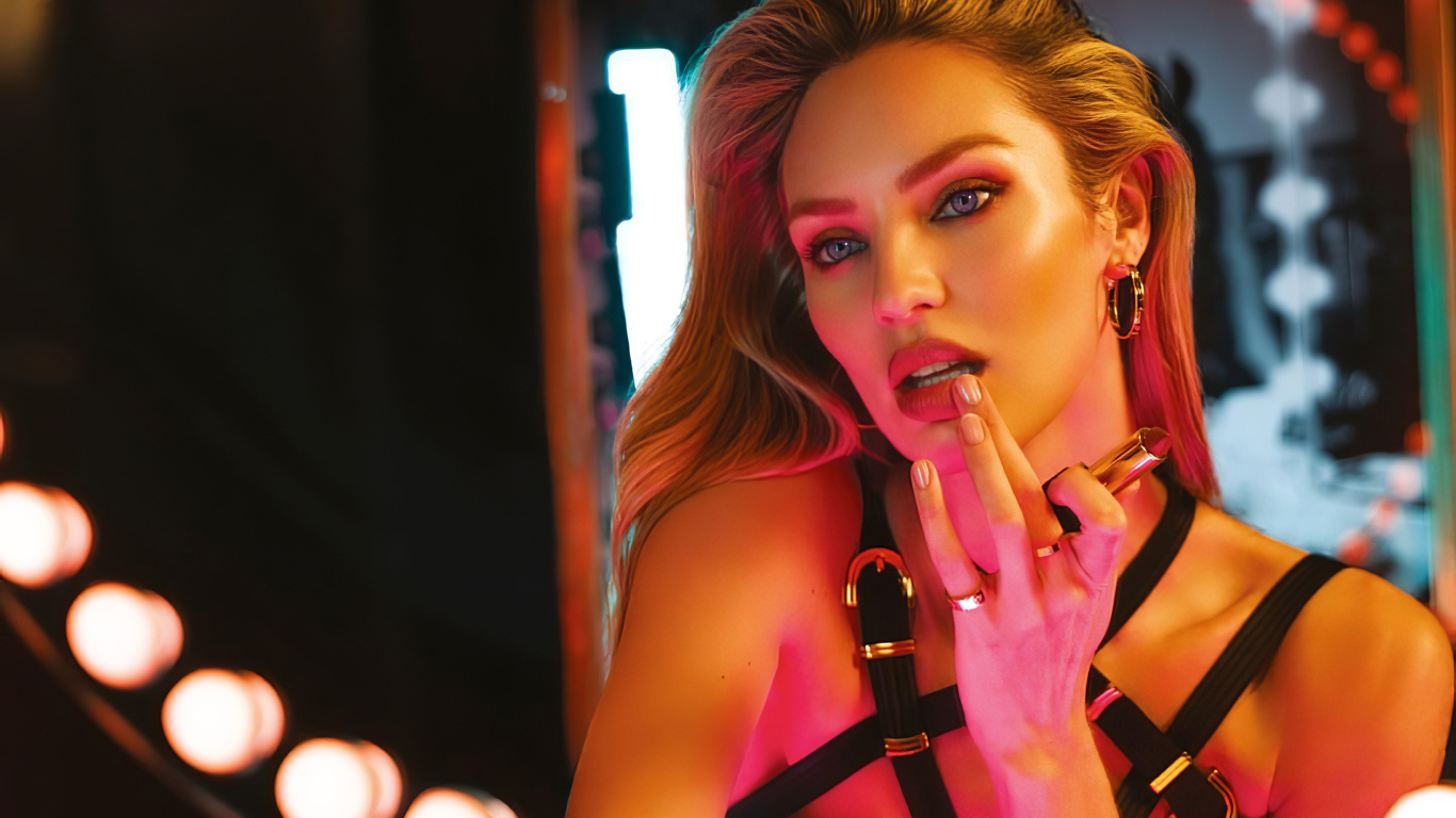 Красивая модель Кэндис Свейнпол красит губы у зеркала