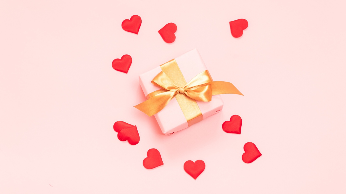 Подарок с бантом на розовом фоне с красными сердечками