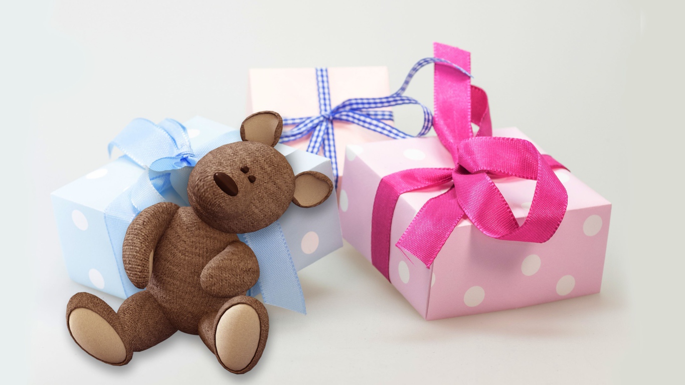 Gifts and teddy bear on a white background