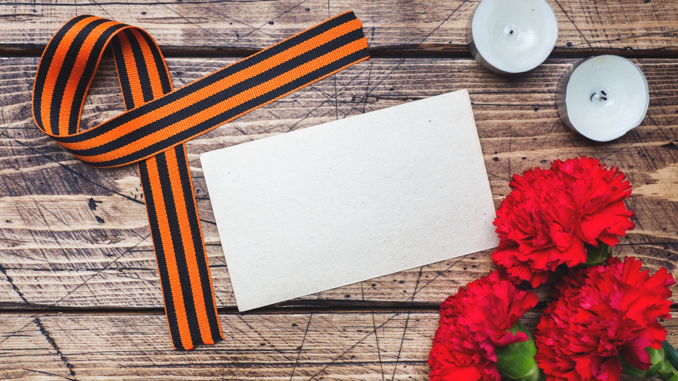 Красные гвоздики, георгиевская лента и свечи на столе, шаблон для открытки на 9 мая День победы