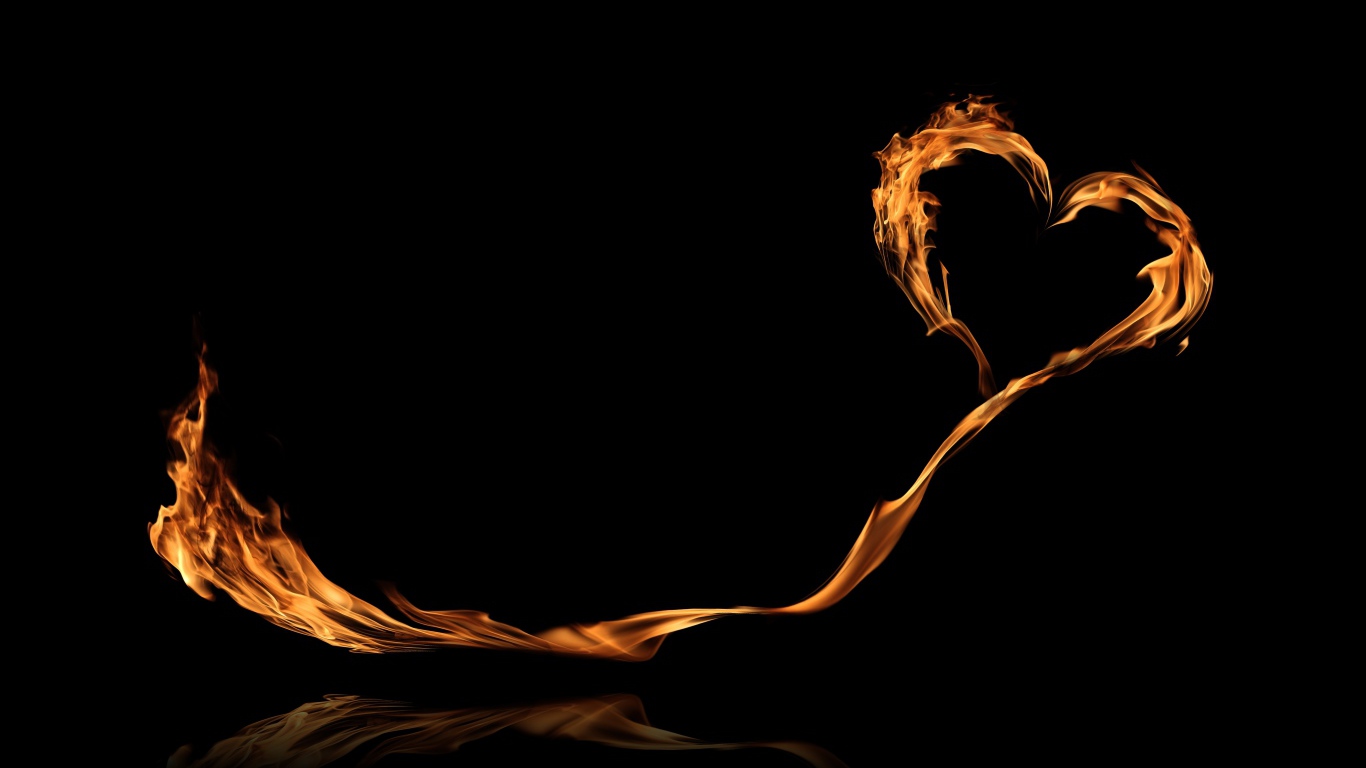 Яркое огненное сердце с длинным хвостом на черном фоне