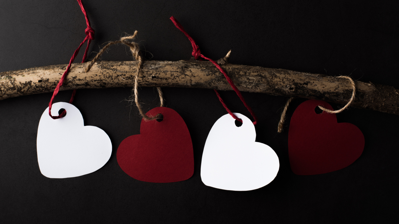 Paper hearts on a branch on a black background