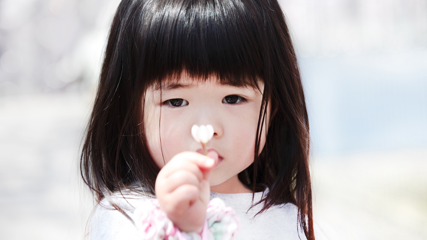 Маленькая девочка азиатка с цветком