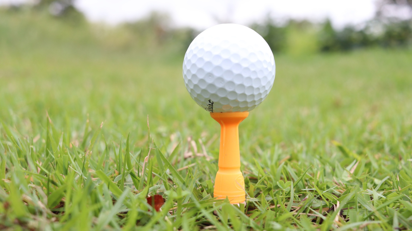 Golf ball on a field with green grass