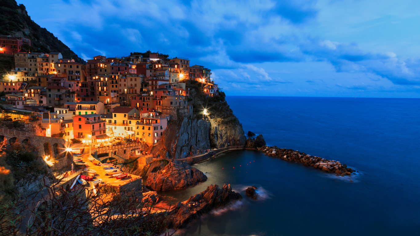 Красивый ночной город Манарола на краю утеса,  Италия