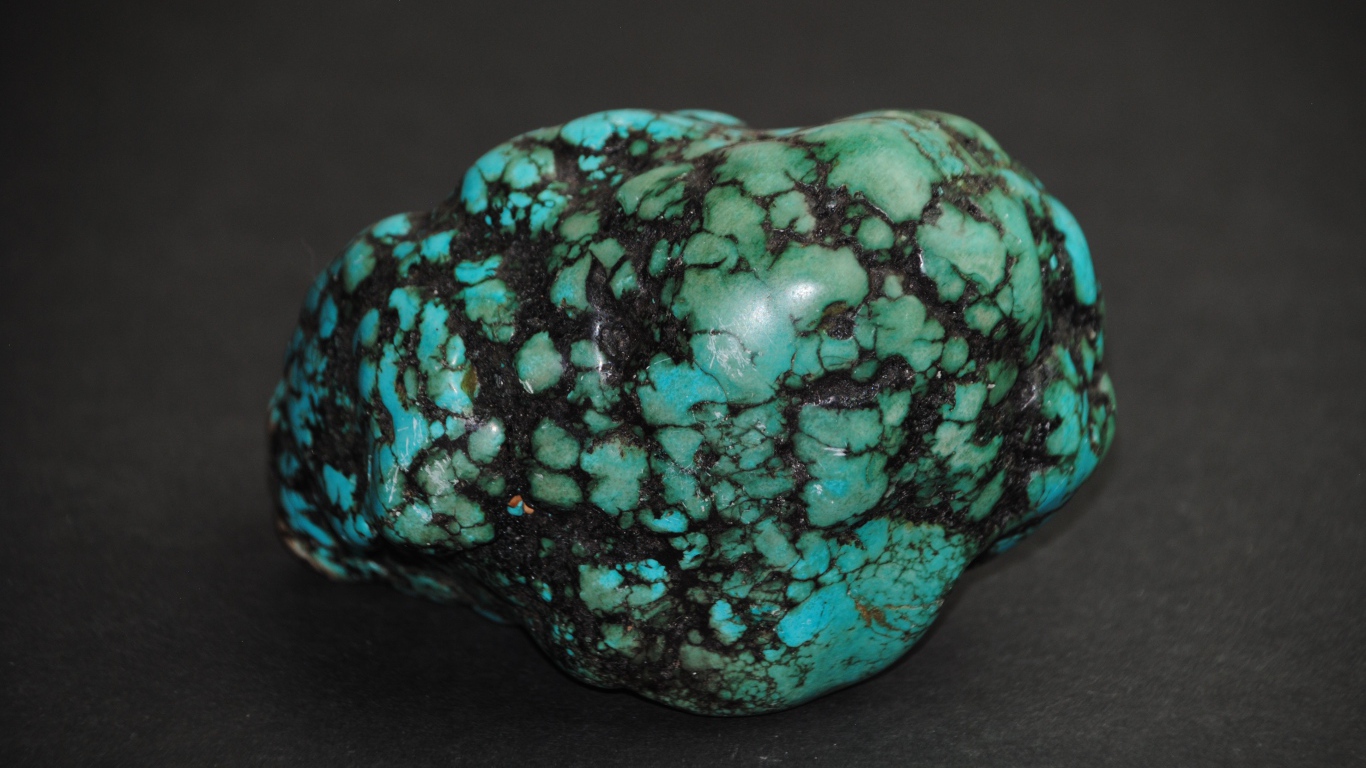 Драгоценный камень бирюзы на сером фоне